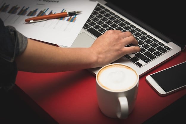 A close-up of a computer screen showing various charts and graphs, with a person's hands hovering over the keyboard and a coffee cup on the desk, indicating data analysis at work.