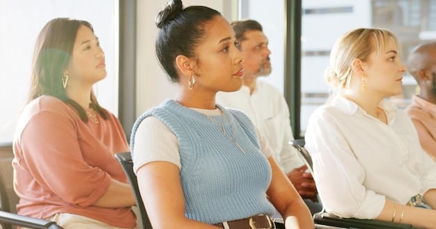 A workshop focused on diversity and inclusion, featuring employees from various backgrounds participating in discussions about cultural sensitivity and workplace equity. The atmosphere is collaborative and positive.