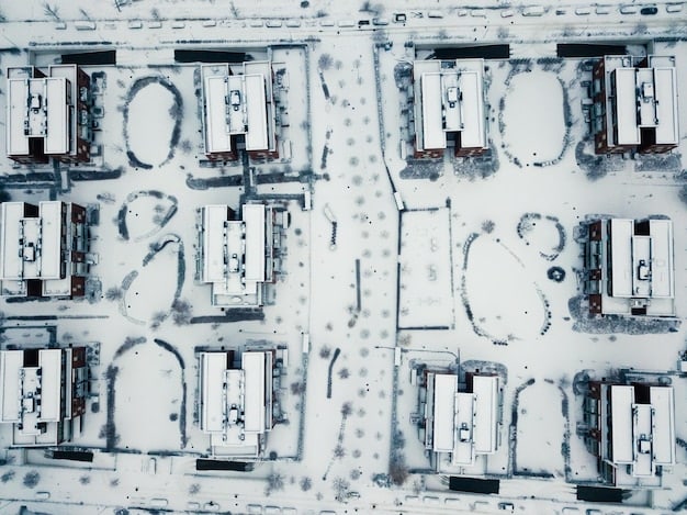 An aerial view of a data center campus located in a colder climate, such as Iceland or Sweden. The location is chosen to leverage natural cooling sources like cooler air and water, reducing the energy needed for cooling systems. The landscape includes green fields and clear water bodies, highlighting the sustainable environment.