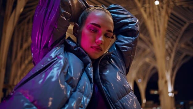Close-up of a model wearing a jacket with integrated LED lights and holographic patterns, showcasing cyberpunk-inspired fashion, with a blurry background of an urban cityscape at night.