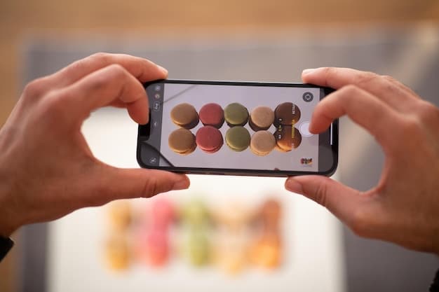 A close-up of a hand holding a smartphone displaying various social media app icons on the screen, with TikTok prominently visible. The background is blurred, suggesting a busy professional setting.