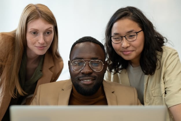 A close-up of a diverse group of US professionals, each engaged with a different digital device (laptop, tablet, smartphone), showing a LinkedIn Learning interface with personalized course recommendations, in a modern, collaborative office setting.
