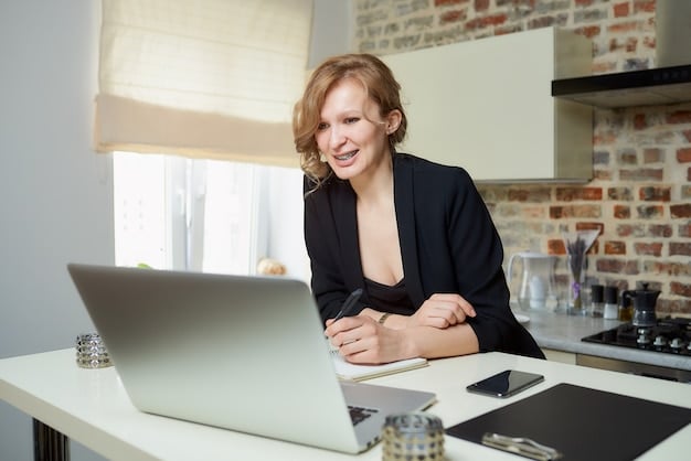 A professional woman in a business casual setting, smiling and looking at a laptop while participating in a virtual event. Her screen shows a LinkedIn Live broadcast with a speaker. This image emphasizes engagement and accessibility in virtual networking.
