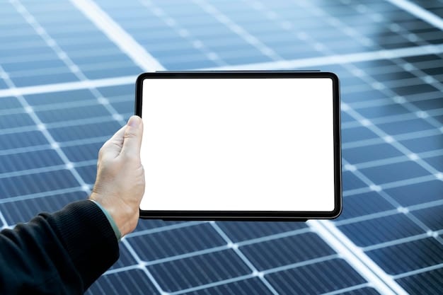 A close-up shot of a hand holding a smart device displaying energy consumption data, with a solar panel array visible in the blurred background, symbolizing advanced energy management.