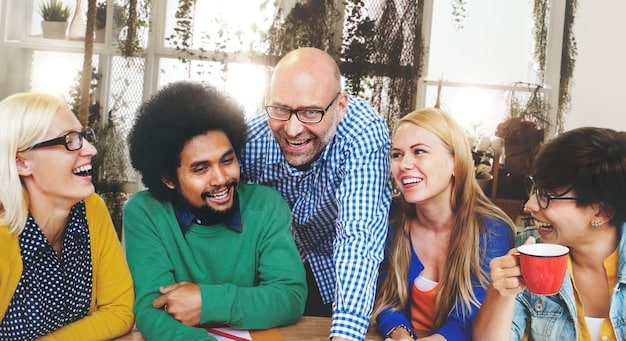 A diverse group of employees laughing and engaging in a team-building activity, symbolizing a positive and inclusive company culture.
