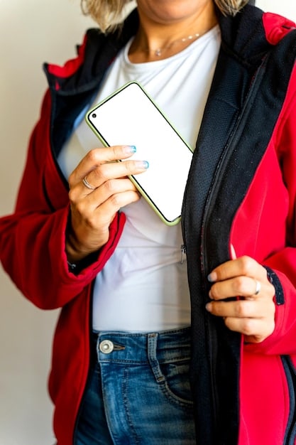 A close-up shot of a young US consumer holding a foldable phone, showcasing its seamless folding mechanism and vibrant display. The background is blurred to emphasize the device and the user's engagement with its unique features.